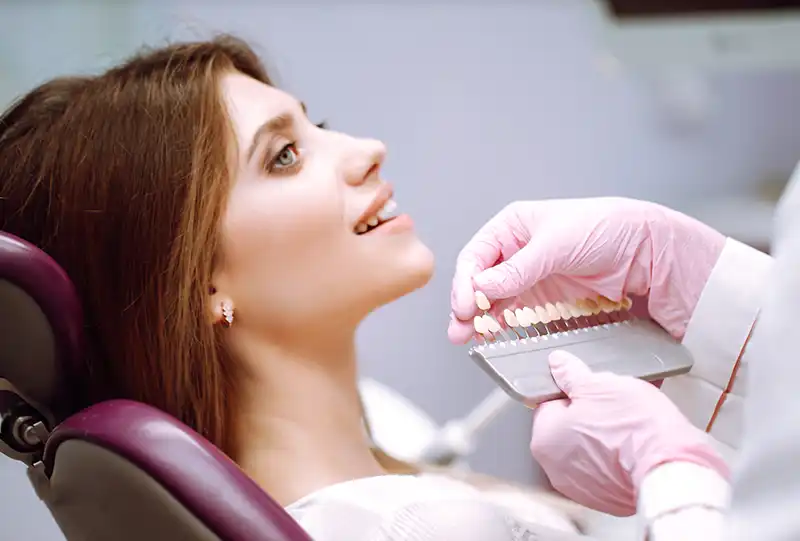 Dentist applying tooth-colored composite resin during a dental bonding procedure at Village Dental Brier Creek in Raleigh