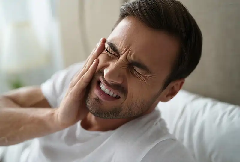 Patient with jaw soreness from nighttime teeth grinding at Village Dental — North Raleigh, NC