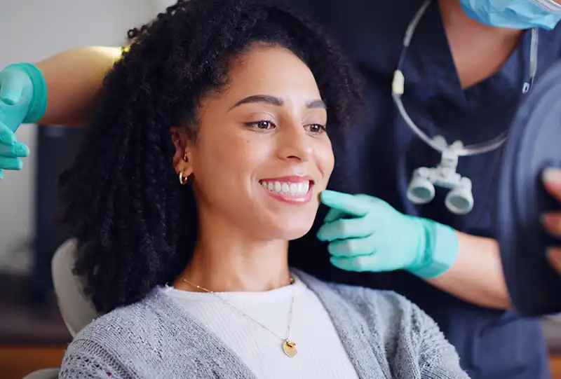 Dental hygienist using an ultrasonic scaler during a professional teeth cleaning at Village Dental Olde Raleigh in Raleigh