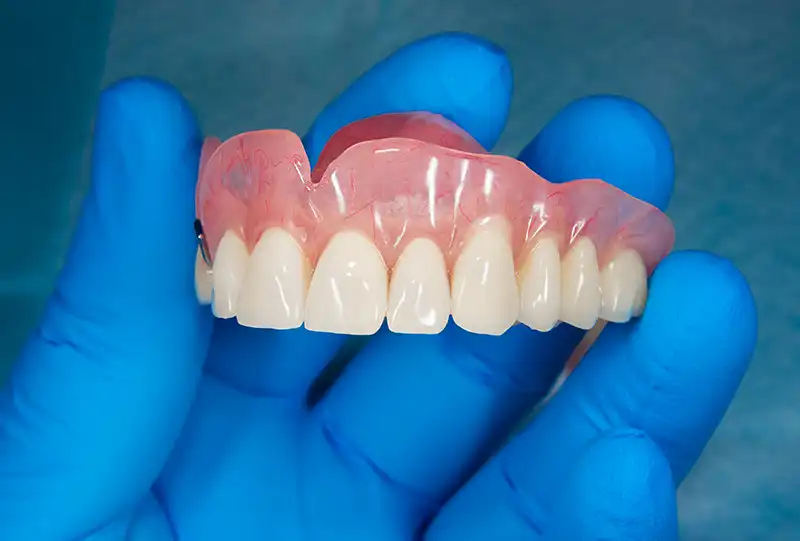 Custom full and partial dentures fabricated for patients at Village Dental in Wake Forest, NC
