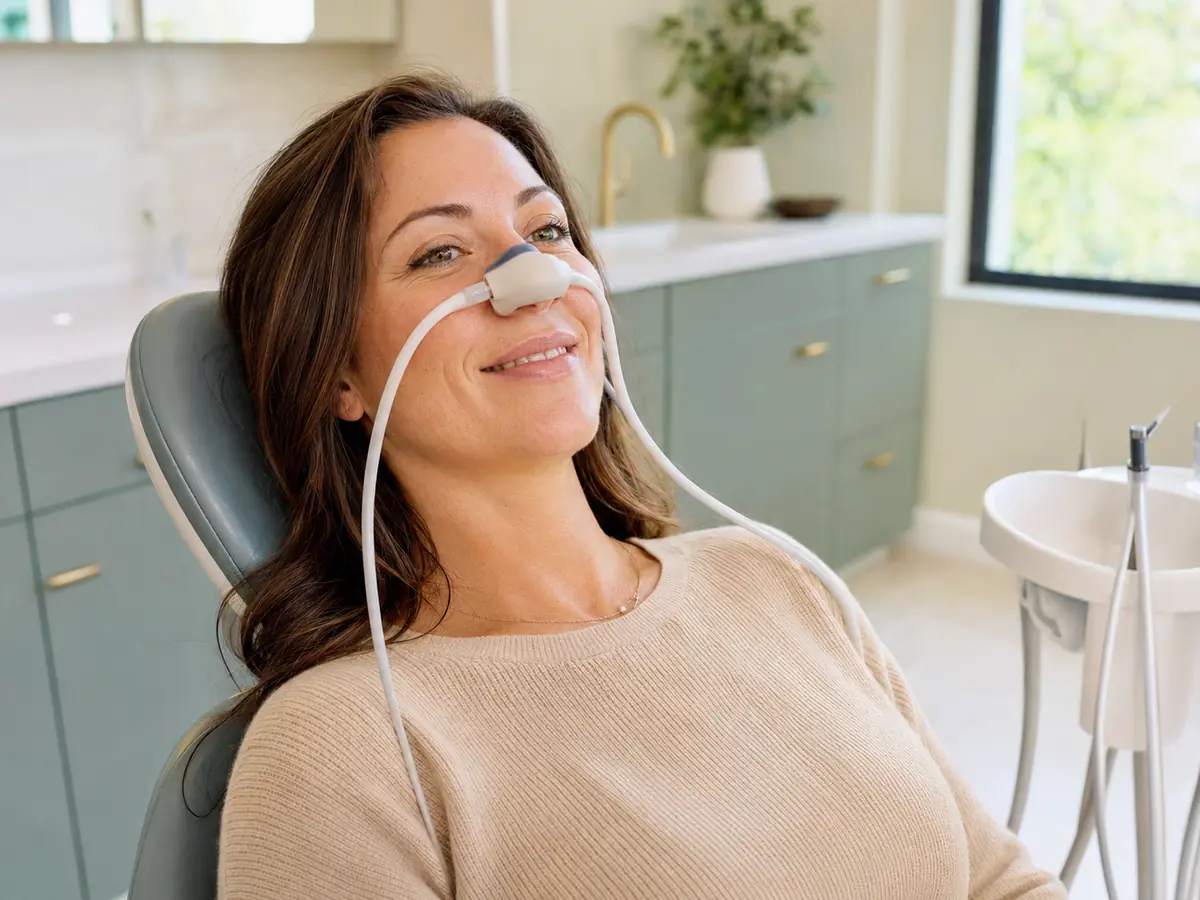 Relaxed patient wearing a nitrous oxide nasal hood at Village Dental in Raleigh, NC