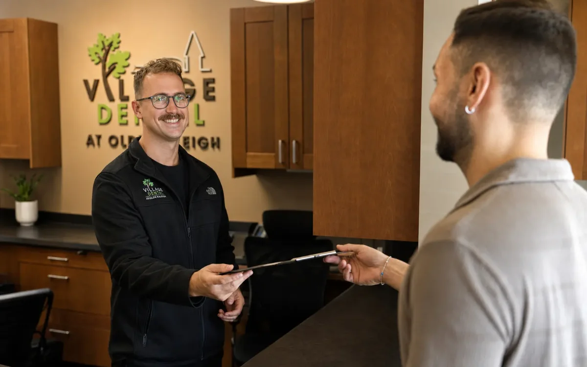 A Village Dental team member welcoming a patient at the Olde Raleigh office